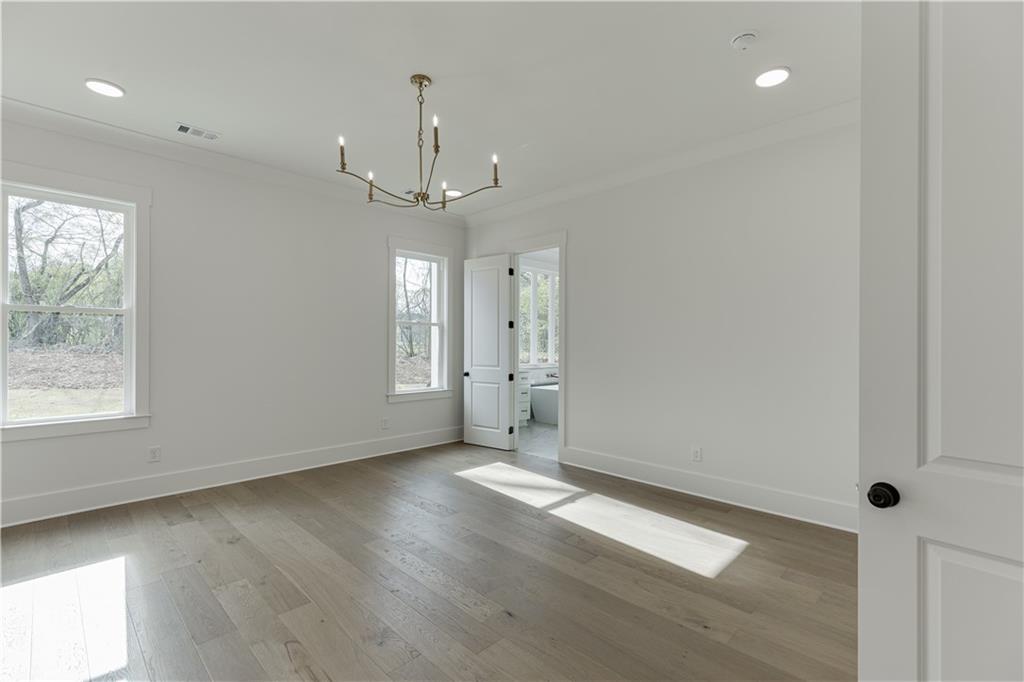 128 Ivey Trace Pendergrass, GA 30567 - Photo 25 of 57 an empty room with wooden floor and windows