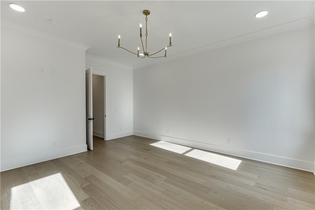 128 Ivey Trace Pendergrass, GA 30567 - Photo 27 of 57 an empty room with wooden floor and ceiling fan