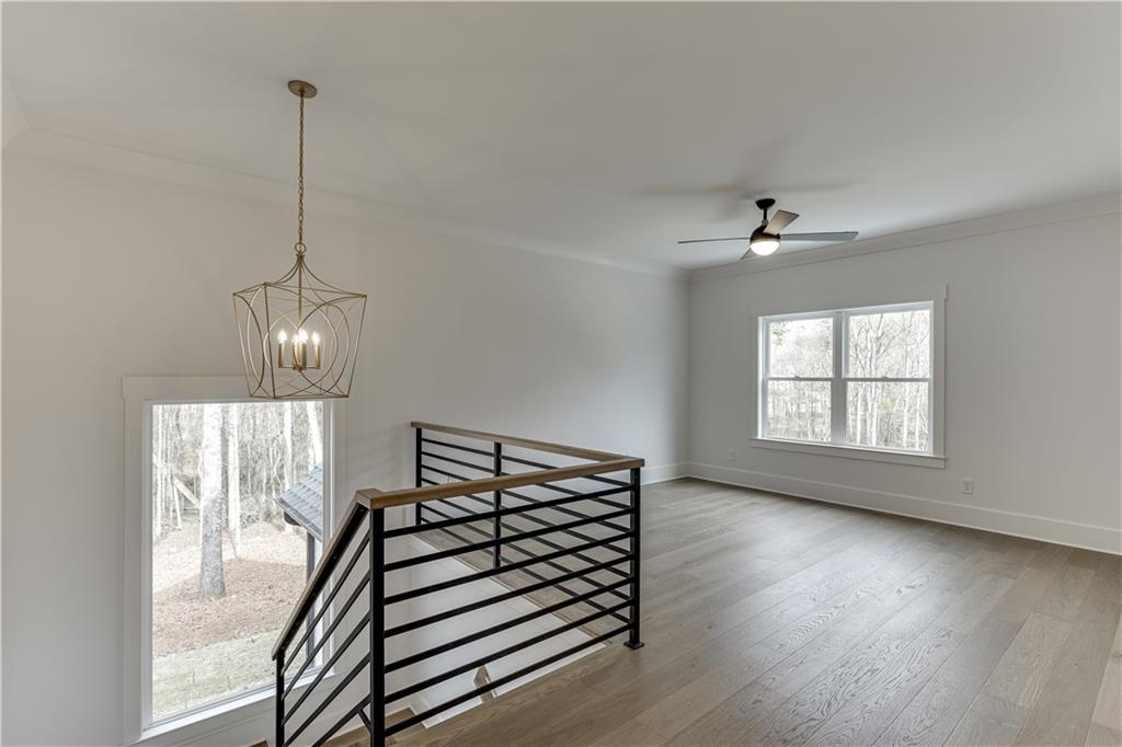 128 Ivey Trace Pendergrass, GA 30567 - Photo 36 of 57 a view of a room with wooden floor fan and windows