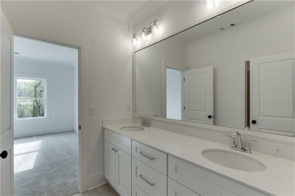 128 Ivey Trace Pendergrass, GA 30567 - Photo 41 of 57 a bathroom with double sink and a mirror
