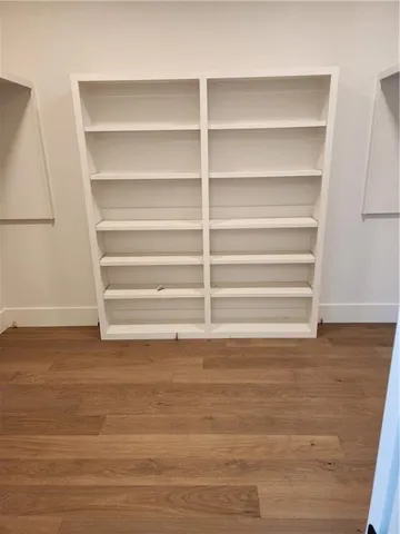 a view of walk in closet with empty racks
