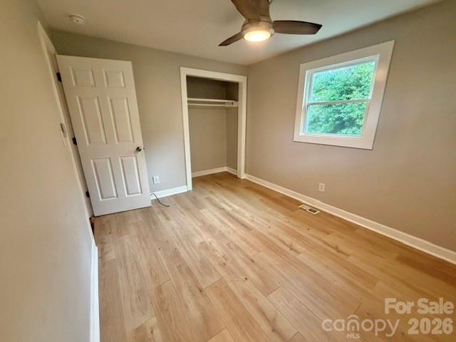 1450 3rd Street Southwest Hickory, NC 28602 - Photo 12 of 17 an empty room with wooden floor fan and windows