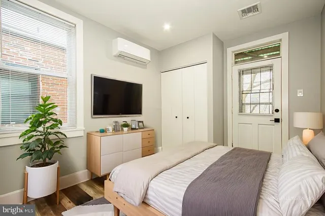 a bedroom with a bed and a flat screen tv