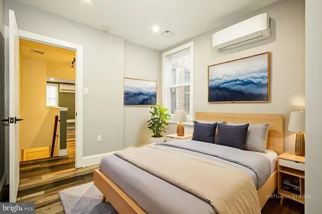 a bedroom with a bed and a painting on the wall