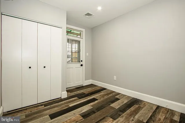 a view of a room with wooden floor