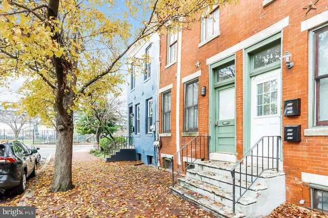 a view of a brick building next to a yard