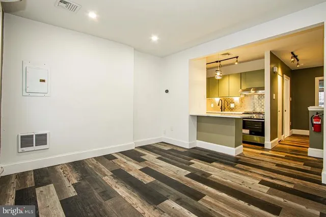 a bedroom with a bed and a view of kitchen