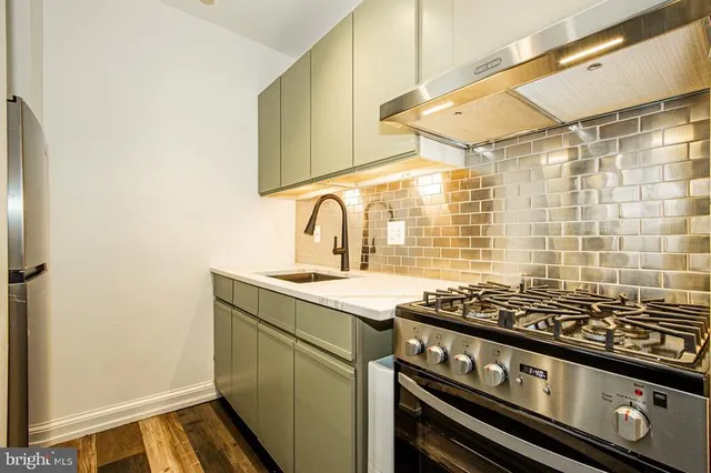 a kitchen with a stove and a sink