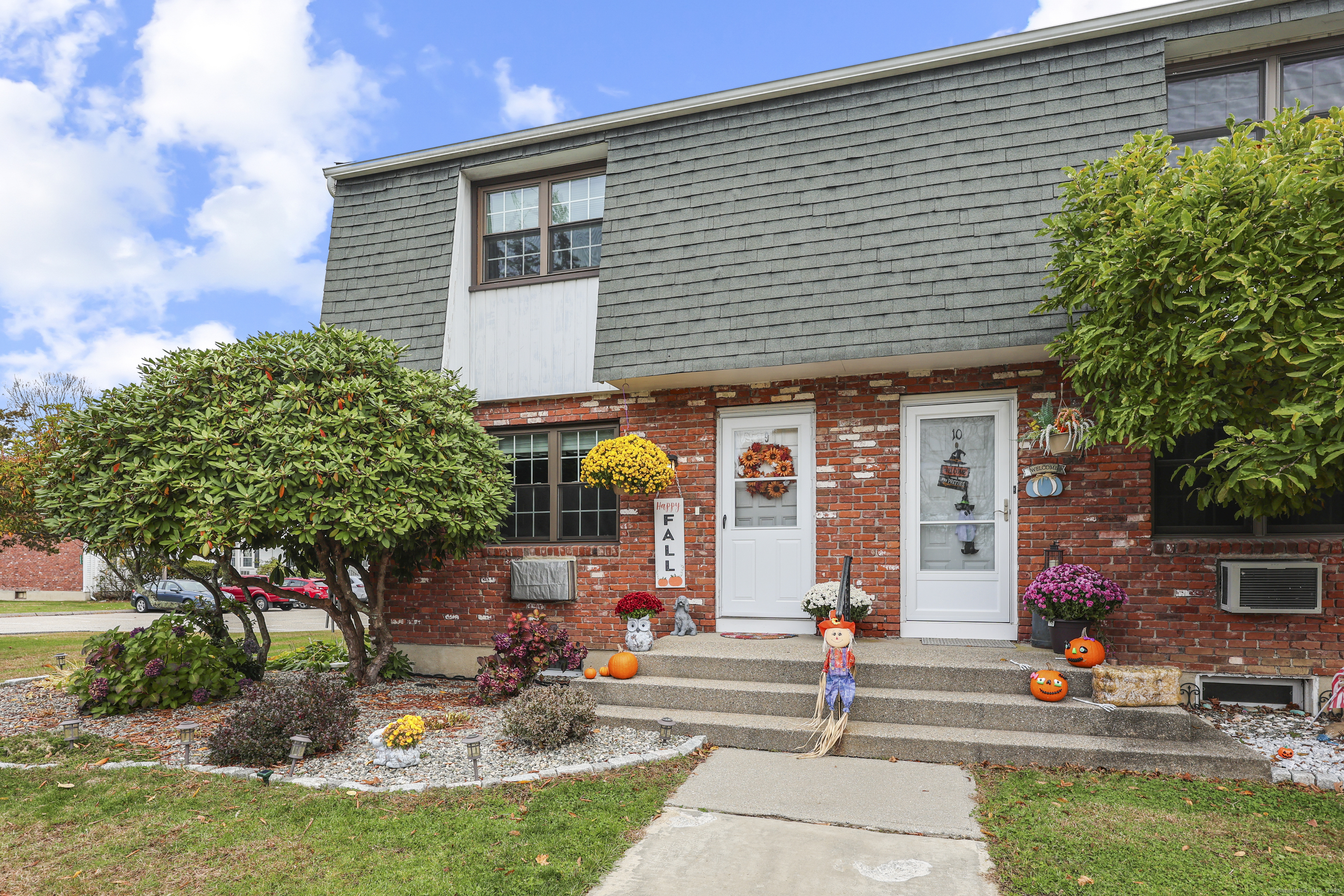 80 Wellswood Road, Unit 9 Hebron, CT 06231 - Photo 1 of 1 a front view of a house with sitting area and garden