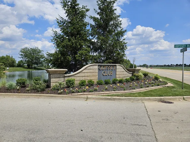 a front view of a house with a yard and lake view