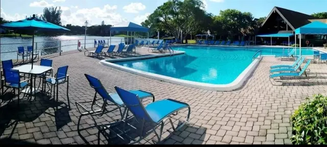 a view of a swimming pool with sitting area