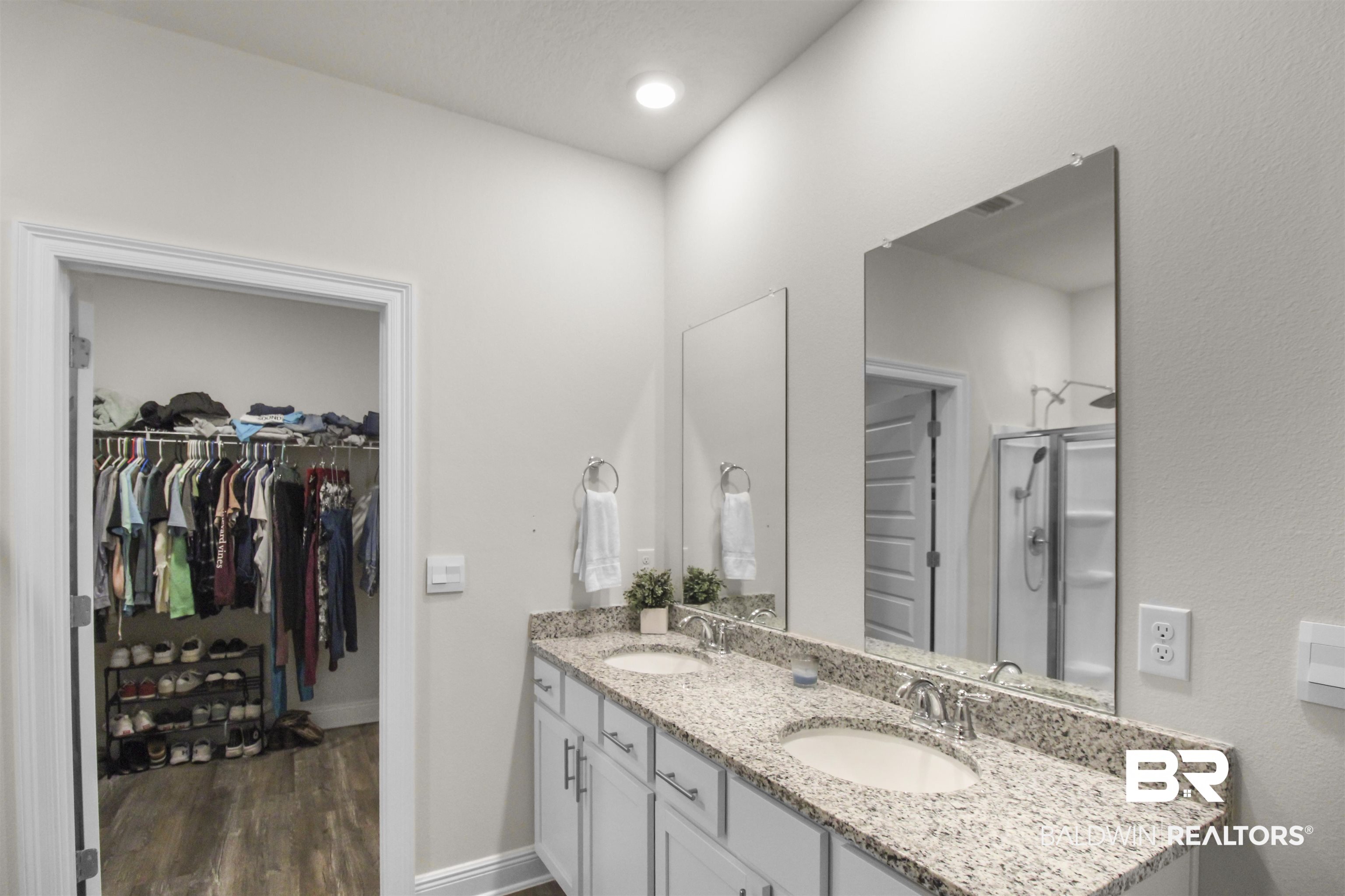 12523 Pheasant Run Elberta, AL 36530 - Photo 21 of 43 Bathroom featuring double vanity, a spacious closet, and dark wood finished floors