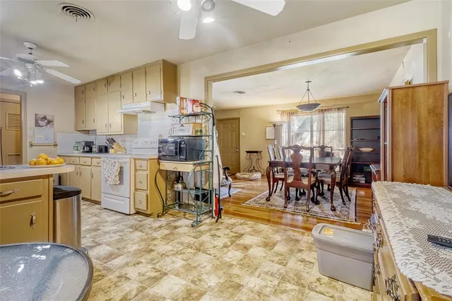 a large kitchen with a table and chairs