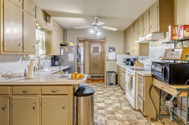 a kitchen with sink cabinets and stainless steel appliances