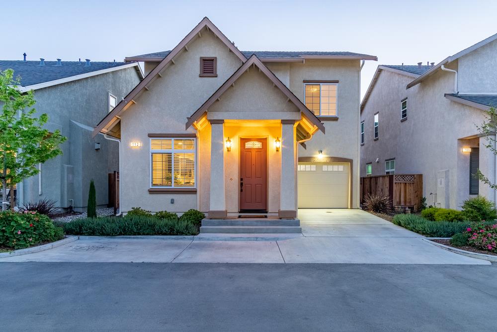 112 Springtime Circle Hollister, CA 95023 - Photo 1 of 63 a front view of a house with a yard and potted plants