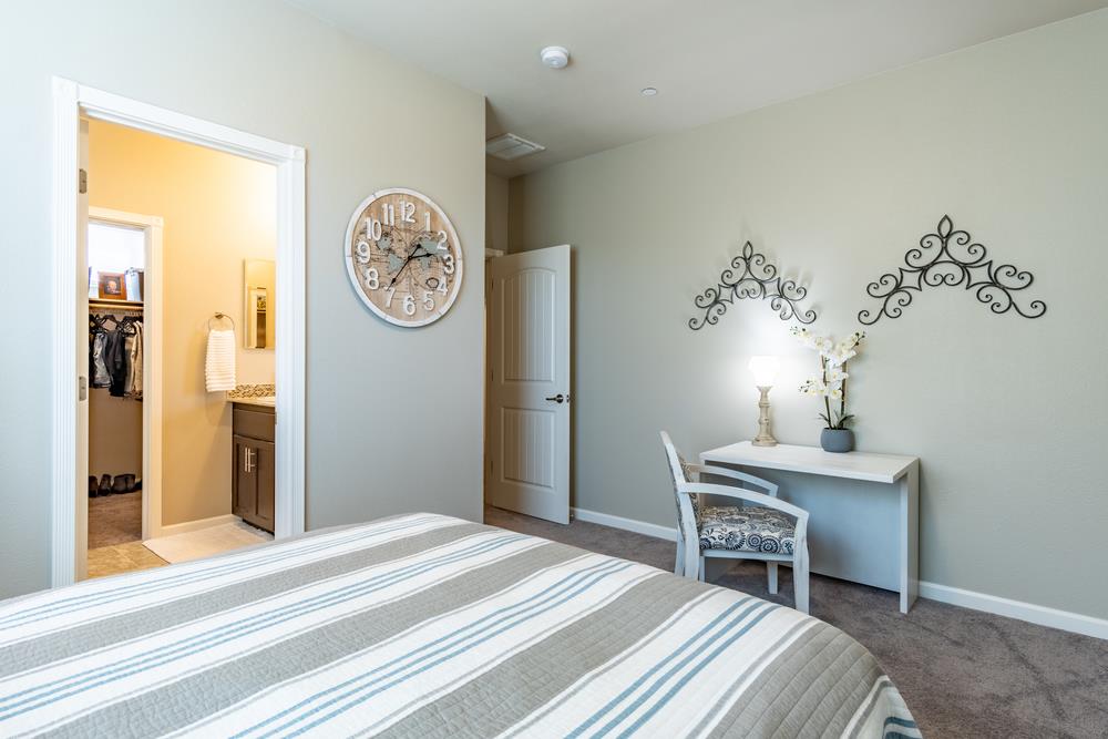 112 Springtime Circle Hollister, CA 95023 - Photo 23 of 63 a bedroom with a bed and a table with chair