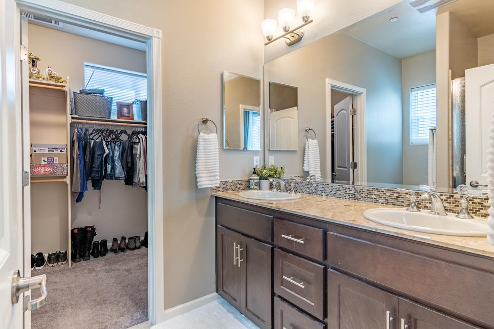 112 Springtime Circle Hollister, CA 95023 - Photo 24 of 63 a bathroom with a granite countertop sink and a mirror