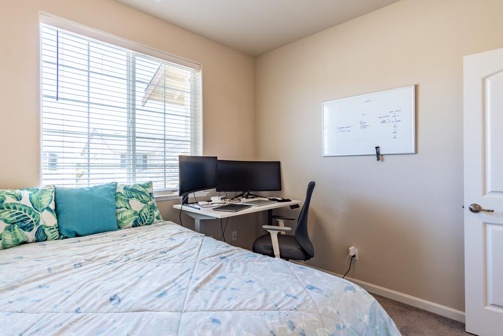 112 Springtime Circle Hollister, CA 95023 - Photo 28 of 63 a bedroom with a bed and a computer on a table