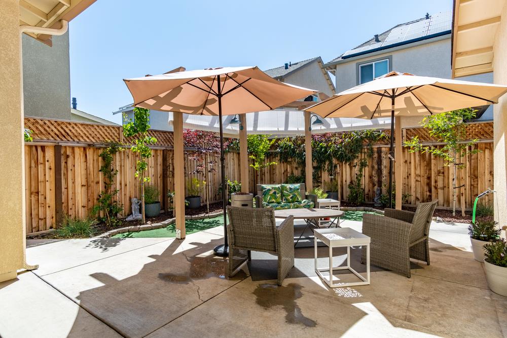 112 Springtime Circle Hollister, CA 95023 - Photo 36 of 63 a patio with a patio table and chairs