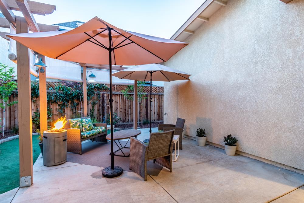 112 Springtime Circle Hollister, CA 95023 - Photo 45 of 63 a view of a patio with a table and chairs under an umbrella