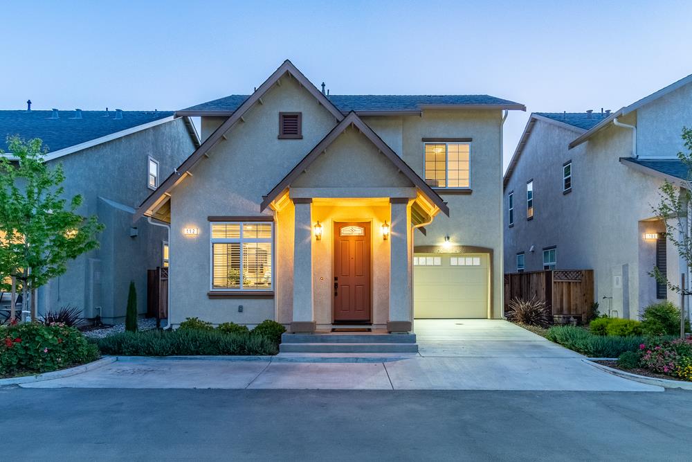 112 Springtime Circle Hollister, CA 95023 - Photo 5 of 63 a view of a brick house with potted plants next to a road