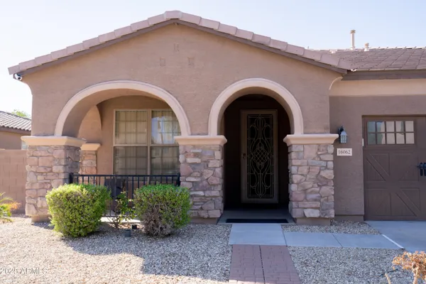 a front view of a house with garden