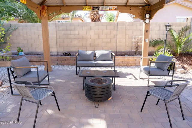 a view of a patio with a table and chairs