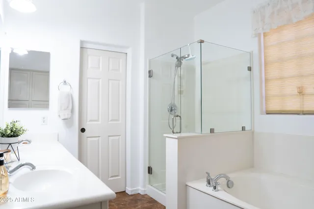 a bathroom with a sink a mirror and a bathtub