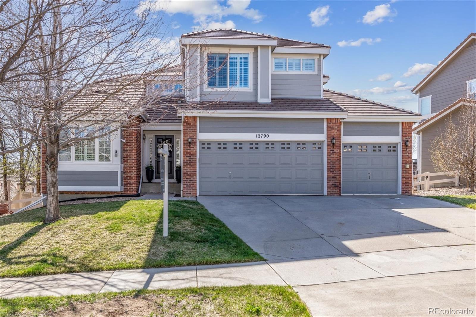 12790 Espera Way Parker, CO 80134 - Photo 1 of 40 a front view of a house with garden