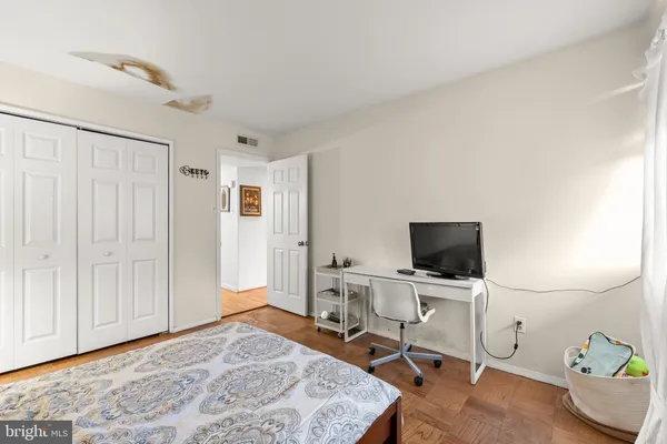 a bedroom with a workspace