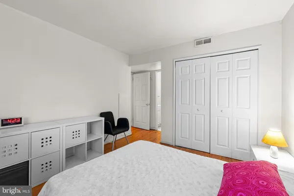 a bedroom with a bed and a closet