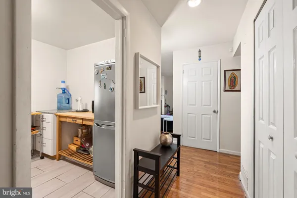 a view of a hallway with bathroom and wooden floor