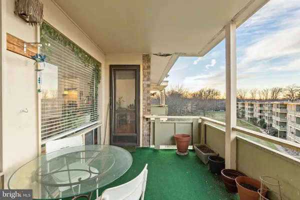 a view of a balcony with table and chairs