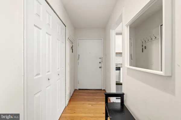 a view of a hallway with wooden floor and staircase