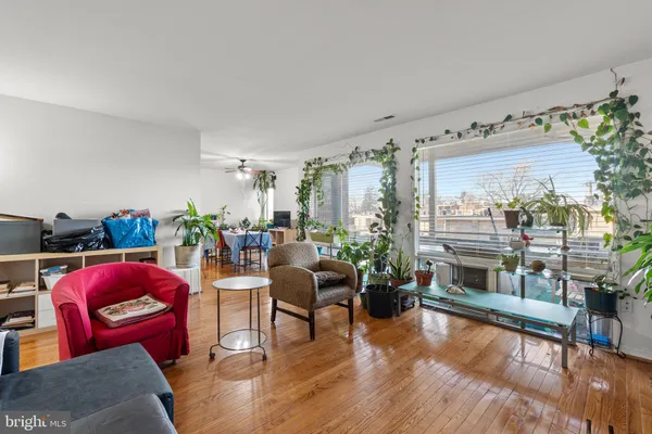 a living room with furniture and a floor to ceiling window