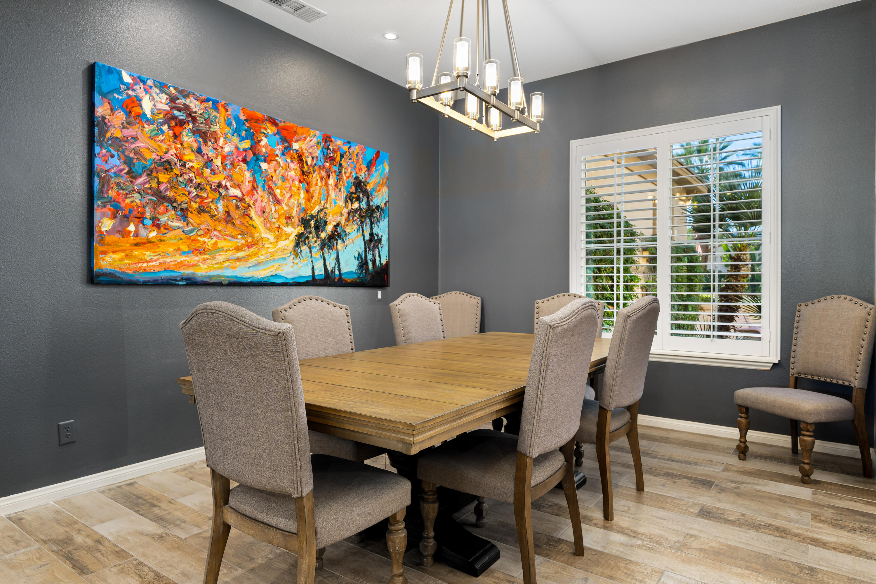 49474 Jordan Street Indio, CA 92201 - Photo 10 of 51 a view of a dining room with furniture a chandelier and wooden floor