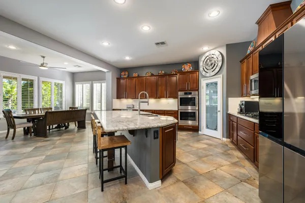a kitchen with cabinets and chairs