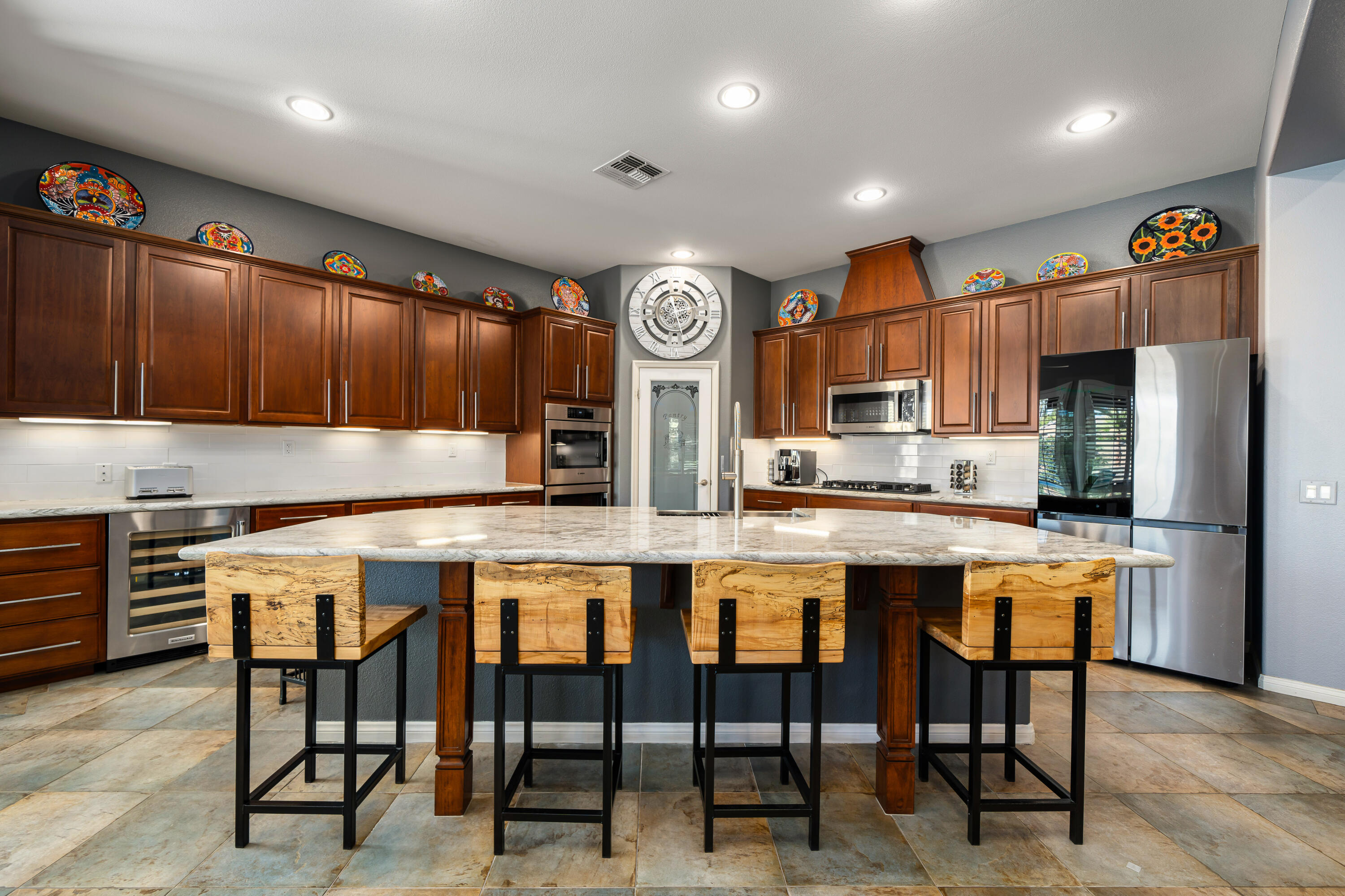 49474 Jordan Street Indio, CA 92201 - Photo 17 of 51 a kitchen with stainless steel appliances granite countertop a table chairs sink and cabinets