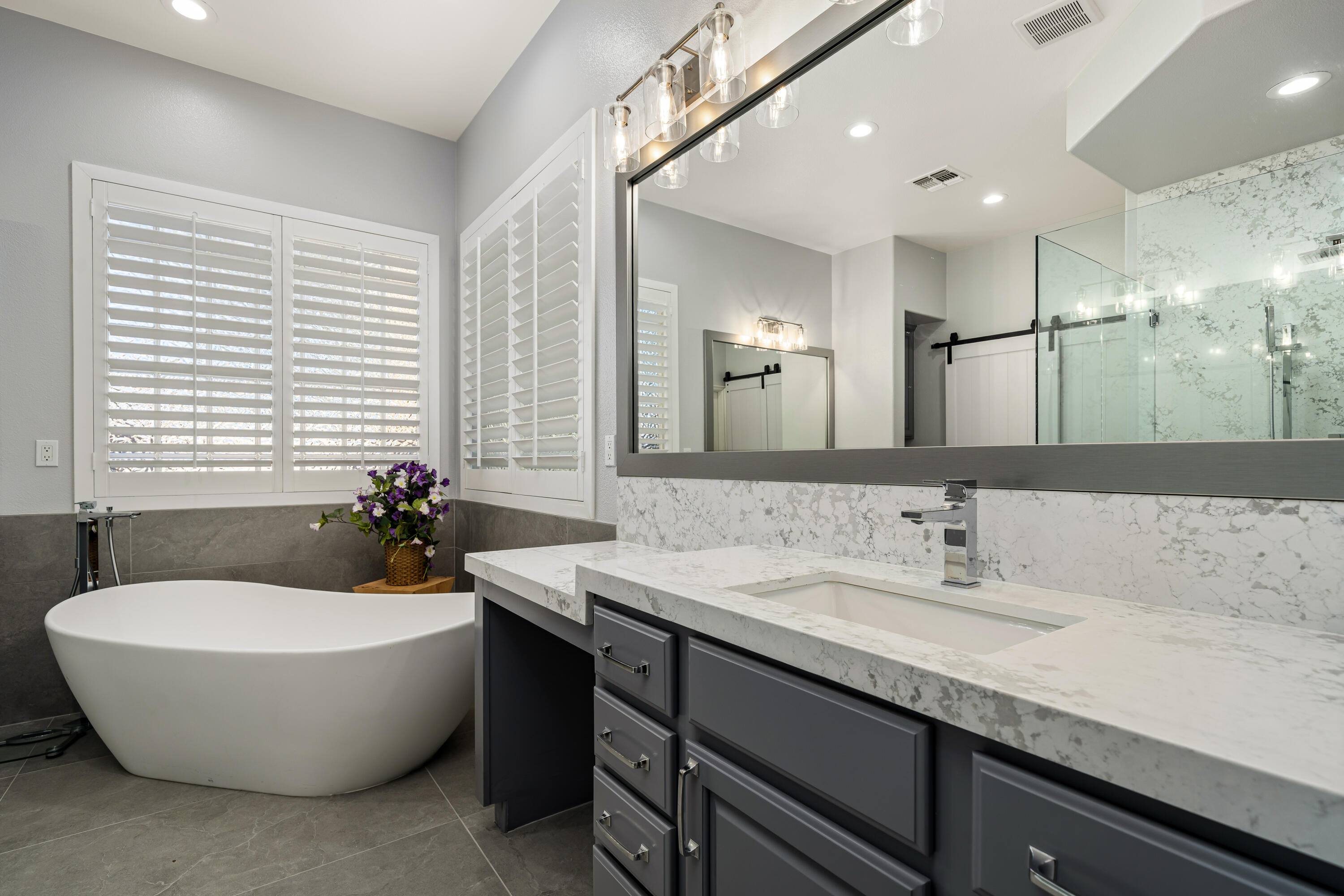 49474 Jordan Street Indio, CA 92201 - Photo 21 of 51 a spacious bathroom with a double vanity sink tub and mirror