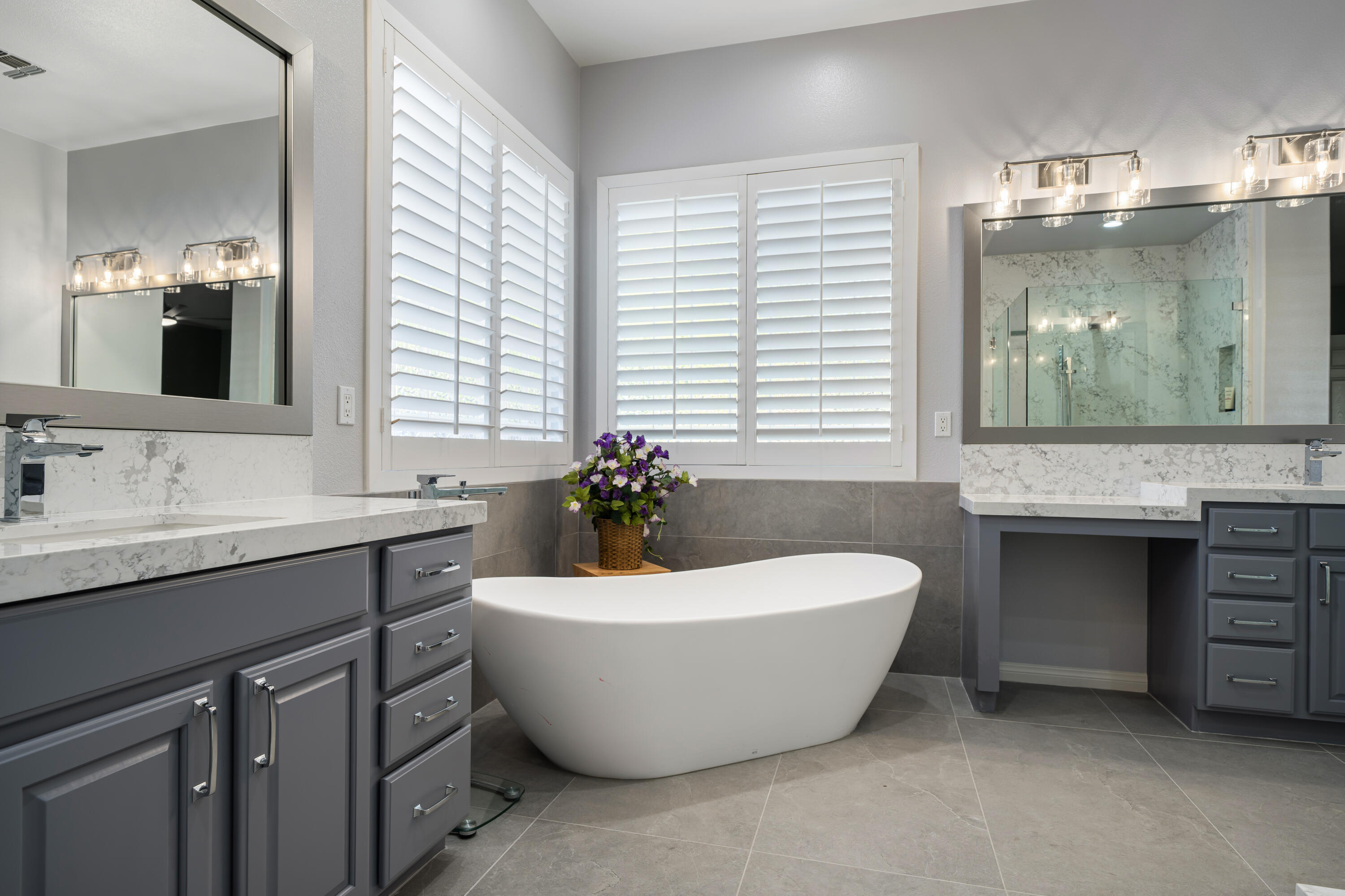 49474 Jordan Street Indio, CA 92201 - Photo 22 of 51 a spacious bathroom with a double vanity sink tub and mirror