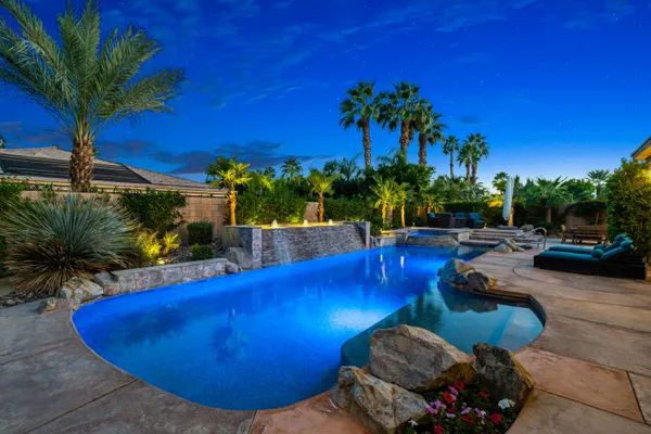 a view of a house with swimming pool and porch