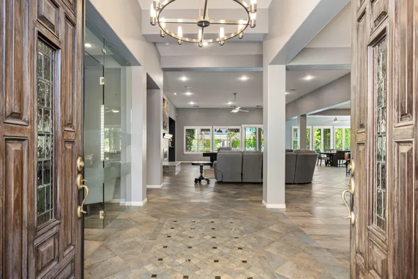 a lobby with furniture and a chandelier