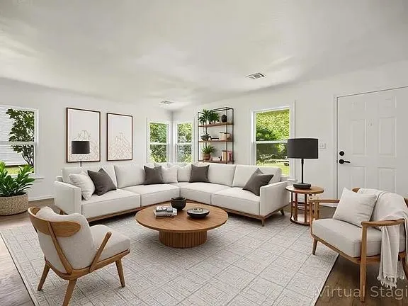 a living room with furniture and a large window