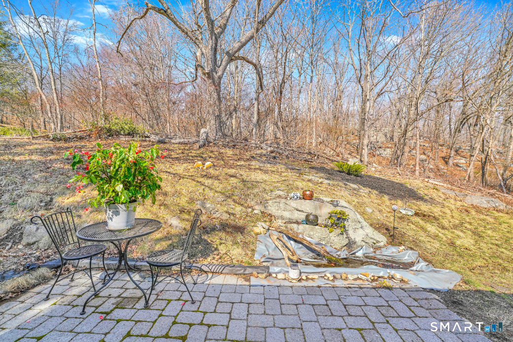 140 Devonwood Drive Waterbury, CT 06708 - Photo 12 of 13 a view of a backyard with table and chairs and potted plants