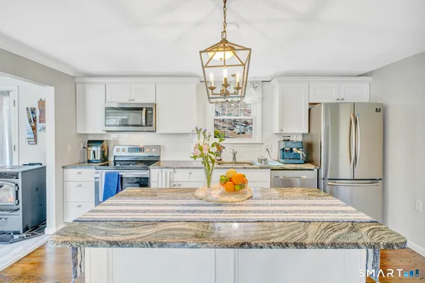 a kitchen with a refrigerator and a sink