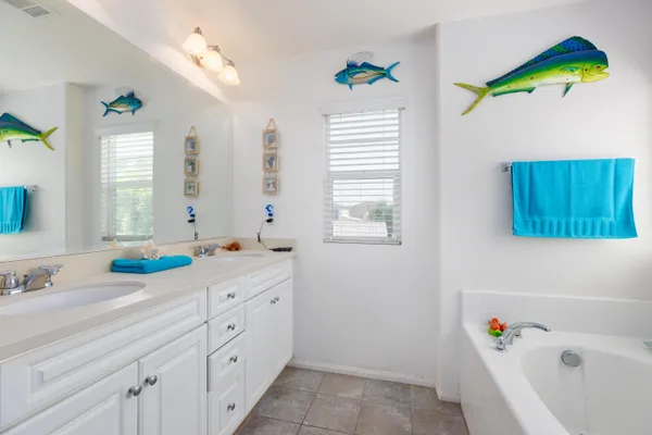 a bathroom with a bathtub a sink and a window