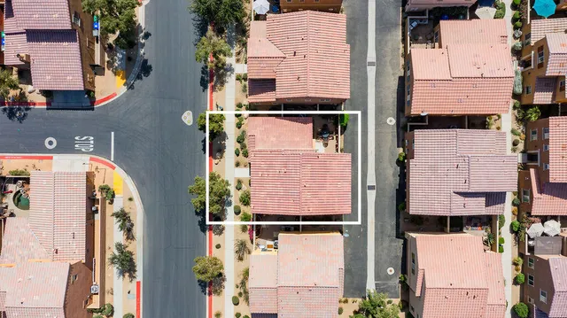 an aerial view of residential houses with outdoor space