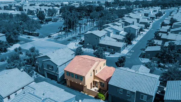 an aerial view of multiple houses with a yard