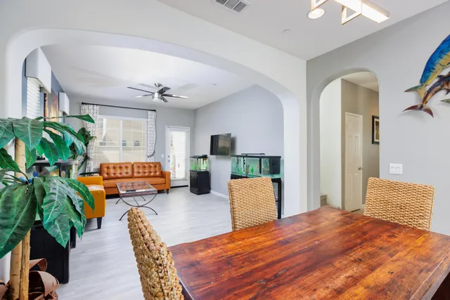 a living room with furniture and a potted plant