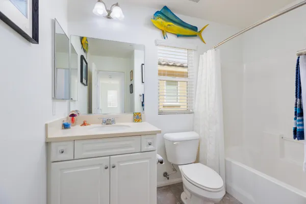 a bathroom with a sink mirror vanity and toilet